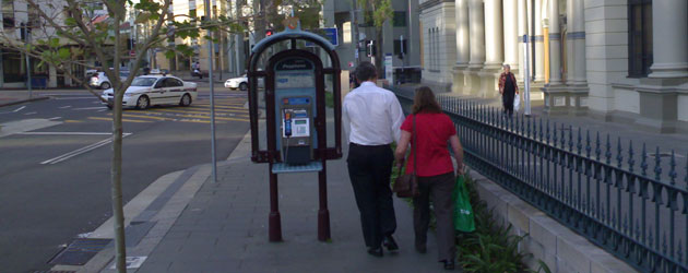 A tight squeeze around the public phone outside St Vincent's Hospital- Jonar Nader