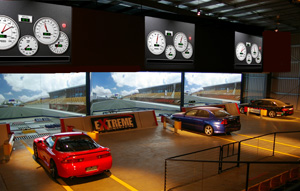 This is the in-ground three-lane simulator at TAG Systems' Victorian office. The company offers a range of education and entertainment technologies, including drag racing. Real boys can thrash their real cars in complete safety. Drivers can each speeds that would otherwise be illegal, if not lethal. By understanding how the car behaves at those speeds, drivers will have first-hand knowledge about the tolerance of their vehicle. They will learn the limitations of physics. Drivers are told to drive safely. The safest drivers are those who know, from experience, what their car can and can't do. Nothing beats finding out for one's self, and this type of system can let them experiment and grow to understand that if they wish to disobey the laws of the land, they can never disobey the laws of physics.